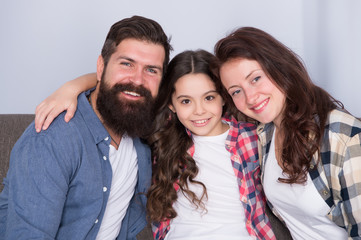 Happy to be a family. trust and relative bonds. bearded man and woman with child. happy family relax at home. family weekend. mother and father love daughter. little girl with parents. family at home