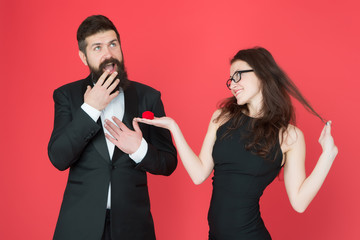 ring is perfect. tuxedo man and elegant lady at engagement party. love date and romance. formal couple. ring in box. valentines day. sexy couple in love. woman make surprised man marriage proposal