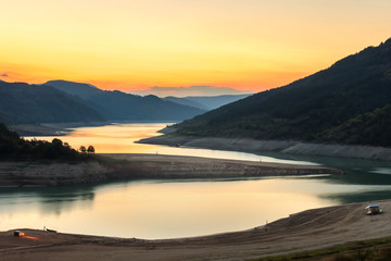 Amazing view of curvy, meandering Zavoj lake on Old mountain at golden hour during it's minimal water level in years 