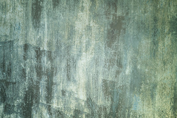 Abstract background with place for text. Old metal fence unevenly painted dirty green and white paint. Unusual pattern.