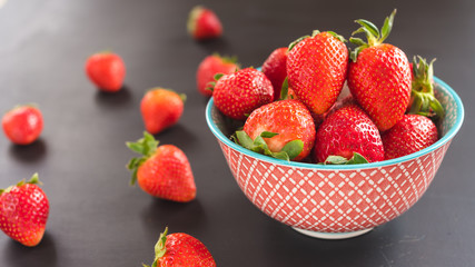 strawberries in the bowl on black background