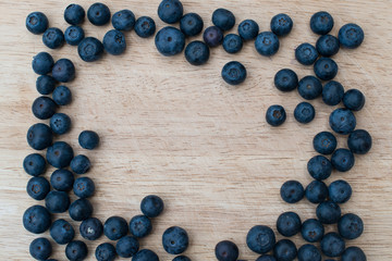Blueberries on a wooden background. Blue berries, healthy food on dark table mockup, berry for smoothie on vintage rustic country board, copy space for text