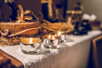 Spa essential aromatic oil in vintage bottle and massage basalt zen stones and candles on the table