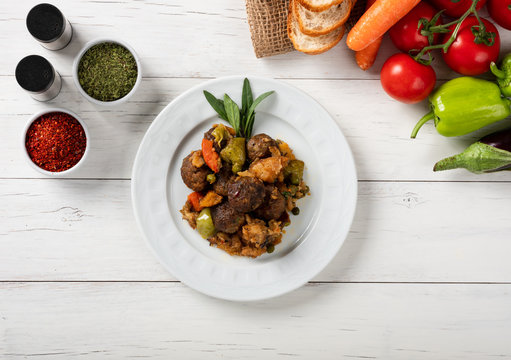 Round meatballs with vegetables in white plate ( Turkish; Misket K&ouml;ftesi )