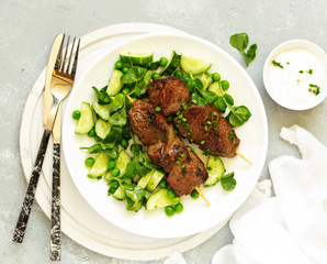 Beef kebab with cucumber and green pea salad. Healthy food.