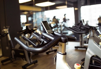Fototapeta premium rows of stationary bike in gym modern fitness center room