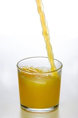 juice of orange into glass on white background with clipping path