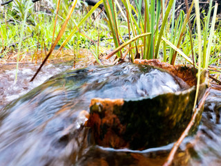 Water from the ground from a rusty pipe. Natural water from the earth.