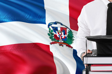 Successful Dominican student education concept. Holding books and graduation cap over Dominican...