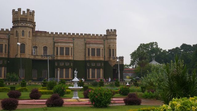 day time famous bangalore city palace front garden slow motion fountain panorama 4k india
