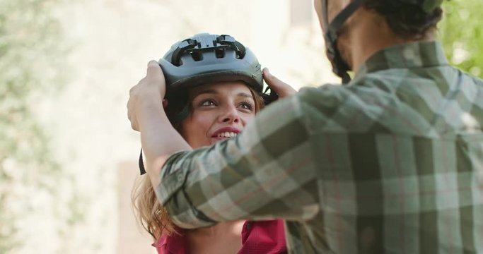 Romantic active couple wearing helmet to riding e-bike bicycles mtb on a beutiful outdoor woods path.Closeshot.Friends italian trip in Umbria.4k slow motion