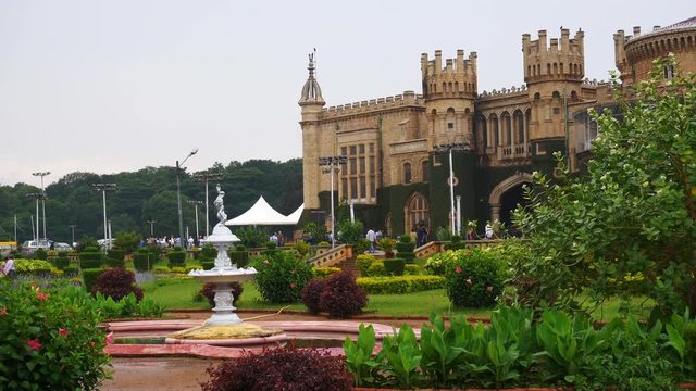 day time famous bangalore city palace front garden slow motion fountain panorama 4k india