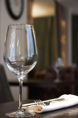 empty wine glass on a table in a restaurant. background is out of focus. interior in a restaurant.
