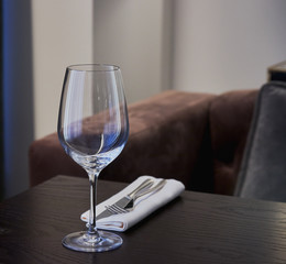 empty wine glass on a table in a restaurant. background is out of focus. interior in a restaurant.