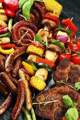 Assorted delicious grilled meat and skewer with vegetable on rustic table