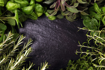 Homegrown and aromatic herbs on rustic background with rosemary and basil