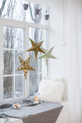 Arch window in a room decorated for celebrating Christmas. Luxury interior in white colors. Frozen mirror