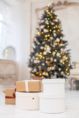 Christmas presents/gifts under fir-tree. Vintage New Year decorations. gift boxes and lantern under fir-tree. Christmas mood. Celebrating of New Year