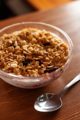Homemade granola with yoghurt and raisins for rustic breakfast