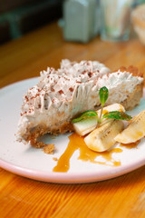Traditional banoffee pie with whipped cream and caramel sauce