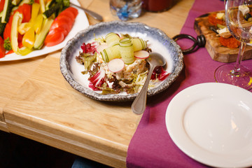 Traditional russian salad with greens on a fancy restaurant dinner party