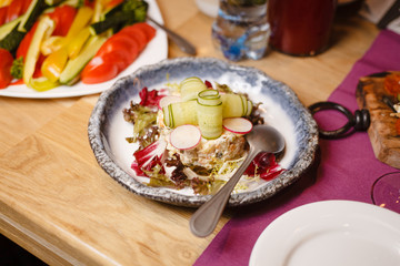 Traditional russian salad with greens on a fancy restaurant dinner party