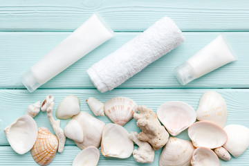 organic Dead Sea cosmetic set with cream and lotion on mint green wooden background top view