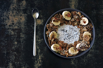 Smoothie bowl with banana, seeds and cereal. Healthy breakfast or dessert.