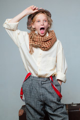 surprise. Travel with old suitcase. Homelss. street kid with dirty face. vintage english style....