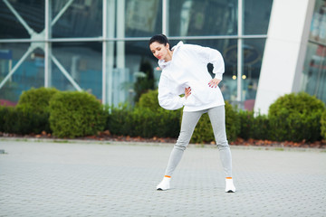 Fitness. Beautiful young woman doing exercises in the park