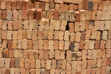 pile of bricks which is prepared for construction. red brick wall at the construction site.