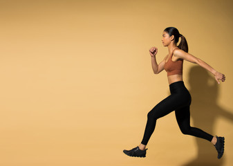 Fototapeta na wymiar Asian slim Fitness woman exercise warm up stretch arms legs, studio lighting yellow beige mustard background shadow copy space, concept Woman Can Do athlete Sport 6 packs