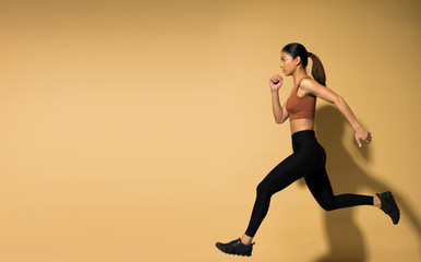 Fototapeta na wymiar Asian slim Fitness woman exercise warm up stretch arms legs, studio lighting yellow beige mustard background shadow copy space, concept Woman Can Do athlete Sport 6 packs
