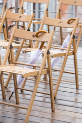 wooden chairs and umbrellas in the rain