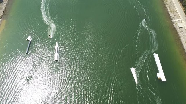 Barcelona. Aerial Wakeboard Cableski traveling Canal Olímpic in Castelldefels, coastal town. Spain. 4k Drone Video