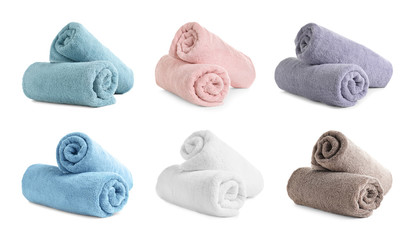Set of rolled soft terry towels on white background