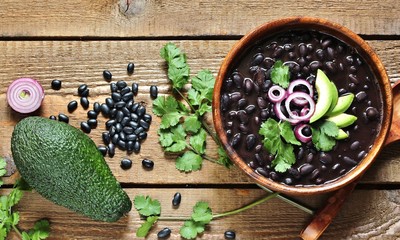 thick black bean soup or stew. Latin American or Mexican cuisine. stewed black beans served with...