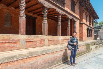 Fototapeta na wymiar An asian man tourist enjoy viewing historic building at Gorakhnath Temple, Nepal