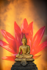 A peaceful superimposed and double exposure images of Golden Buddha statue from Wat Pathum Wanaram, Bangkok, Thailand and a beautiful pink lotus. Buddha statue posing “The attitude of subduing Mara”.