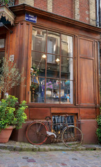 Naklejka na ściany i meble Old bicycle outside a merchant shop