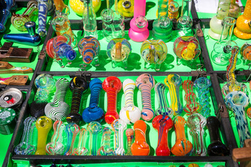 Various types of glass smoking pipes for marijuana for sale. - obrazy, fototapety, plakaty