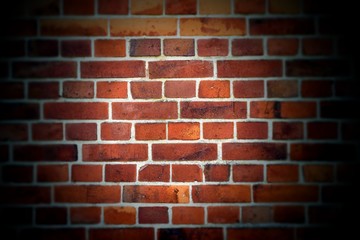 Texture of red brick wall with vignette. Background of red brick wall