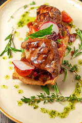 Grilled meat on pita bread on a bright oval plate. Dark wooden background. Restaurant menu
