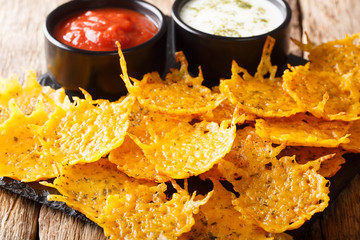 Herb cheddar chips served with sauces close-up on a board. horizontal