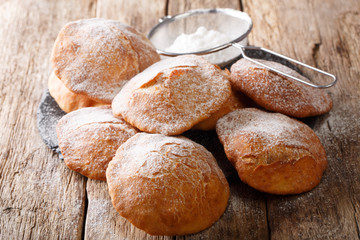 Bunuelos homemade donuts sprinkled with powdered sugar close-up. horizontal