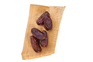 sweet dried dates fruit on dried banana leaf
