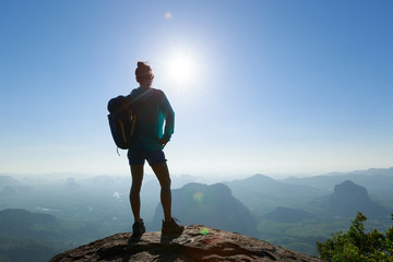 Obraz premium Successful woman hiker enjoy the beautiful landscape in the sunrise mountain peak cliff edge