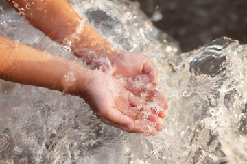 Hand of children get some water for drink from tap, Water scarcity concept.