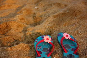 flower pattren on bule sandals on beach.