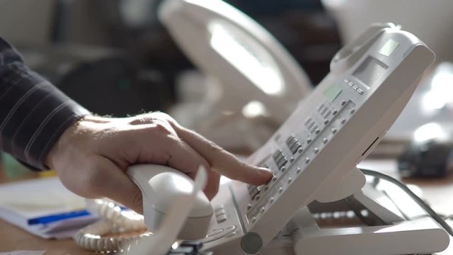 The analog phone - close-up view. The sales manager dials the customer's number.